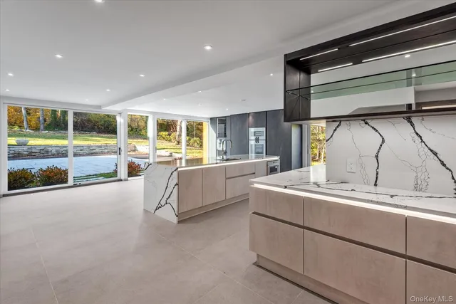 a large kitchen with stainless steel appliances kitchen island a large counter top