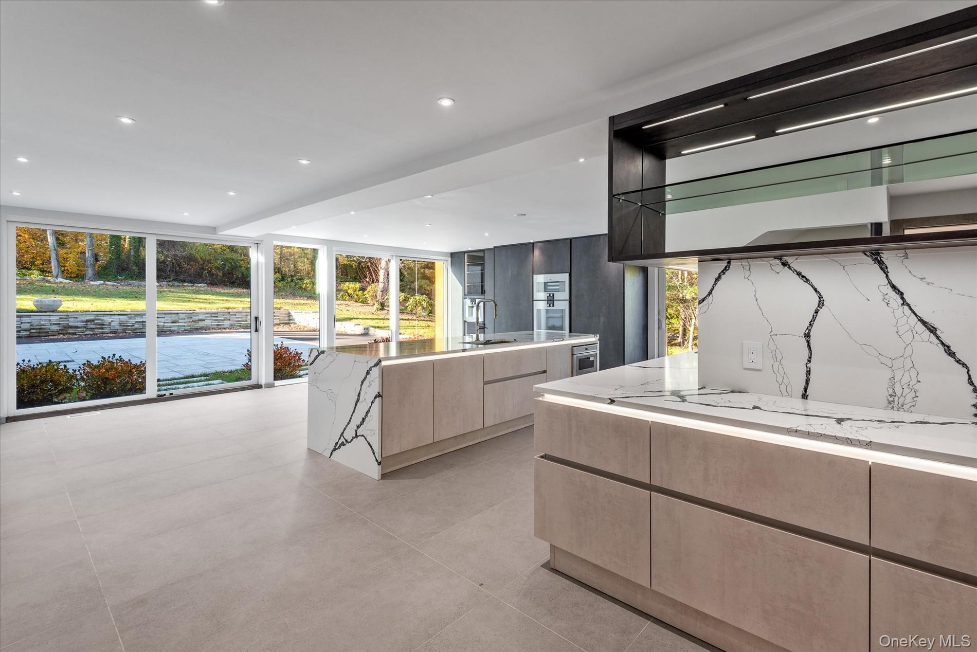 369 East Shore Road Great Neck, NY 11023 - Photo 15 of 50 a large kitchen with stainless steel appliances kitchen island a large counter top