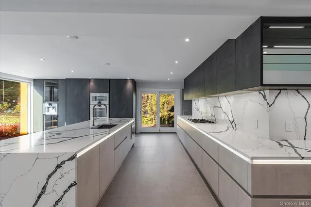 a large white kitchen with a large window