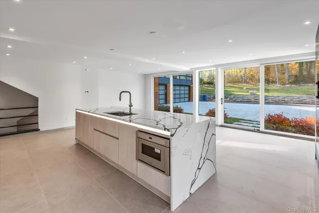 a kitchen with sink and large window