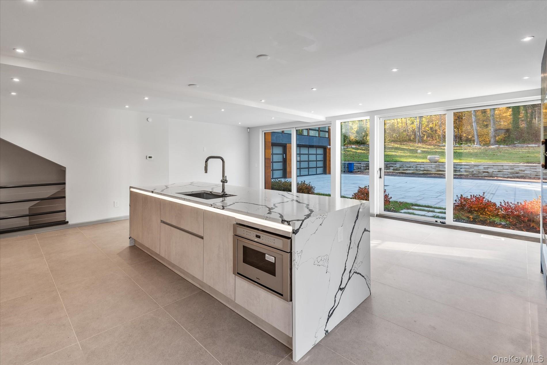 369 East Shore Road Great Neck, NY 11023 - Photo 17 of 50 a kitchen with sink and large window