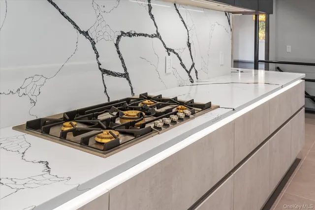 a bathroom with a stove and a wooden floor