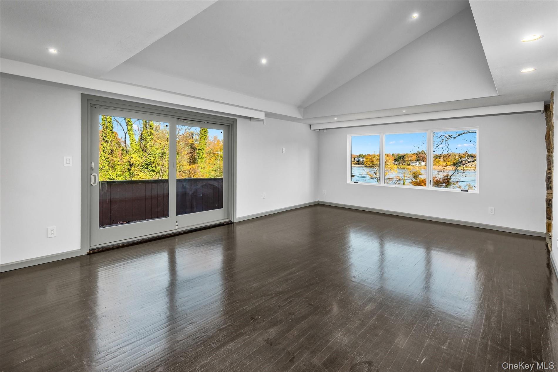 369 East Shore Road Great Neck, NY 11023 - Photo 25 of 50 an empty room with wooden floor and windows