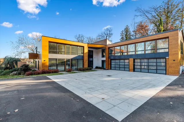 a view of a house with a backyard and basketball court