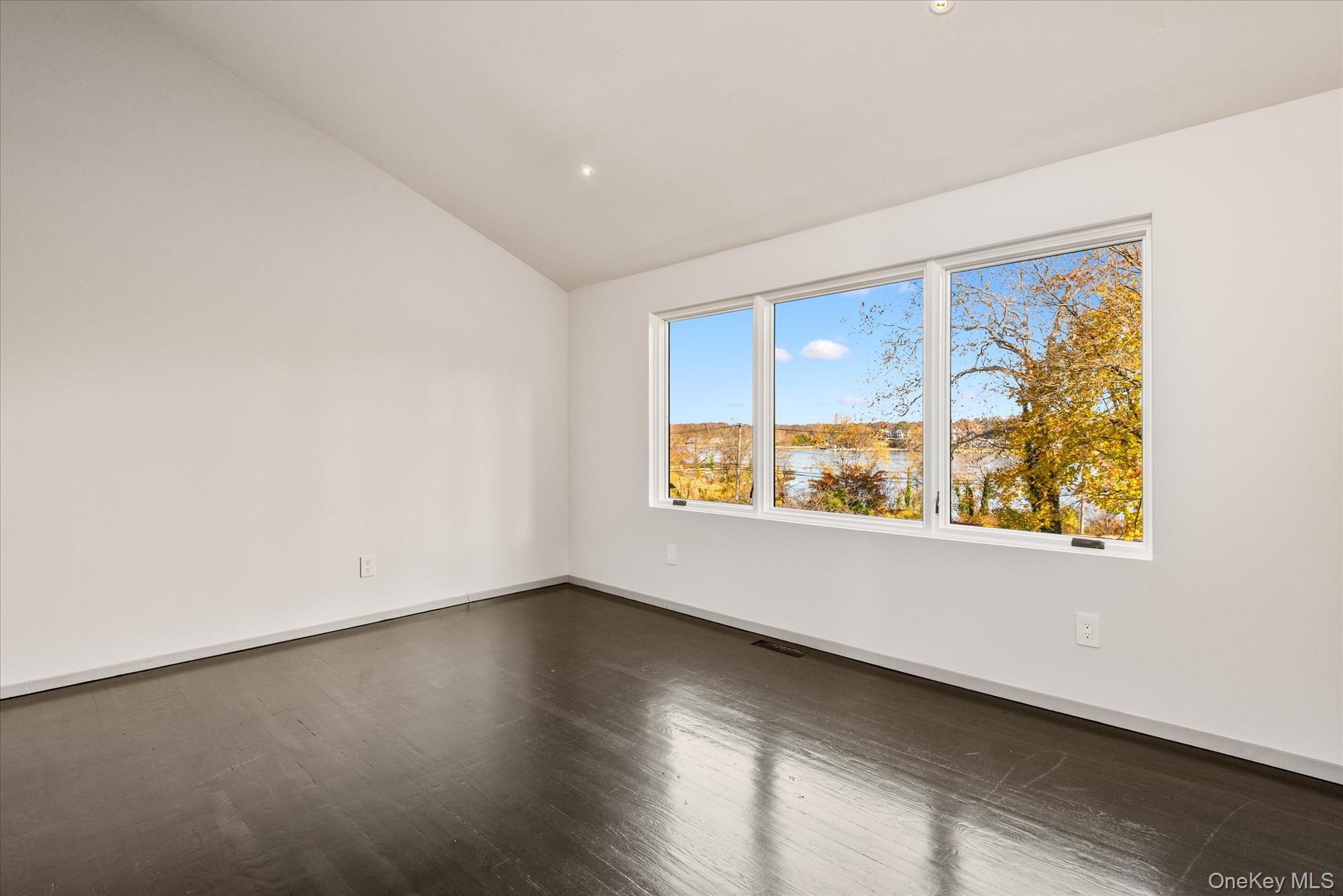 369 East Shore Road Great Neck, NY 11023 - Photo 33 of 50 an empty room with wooden floor and windows