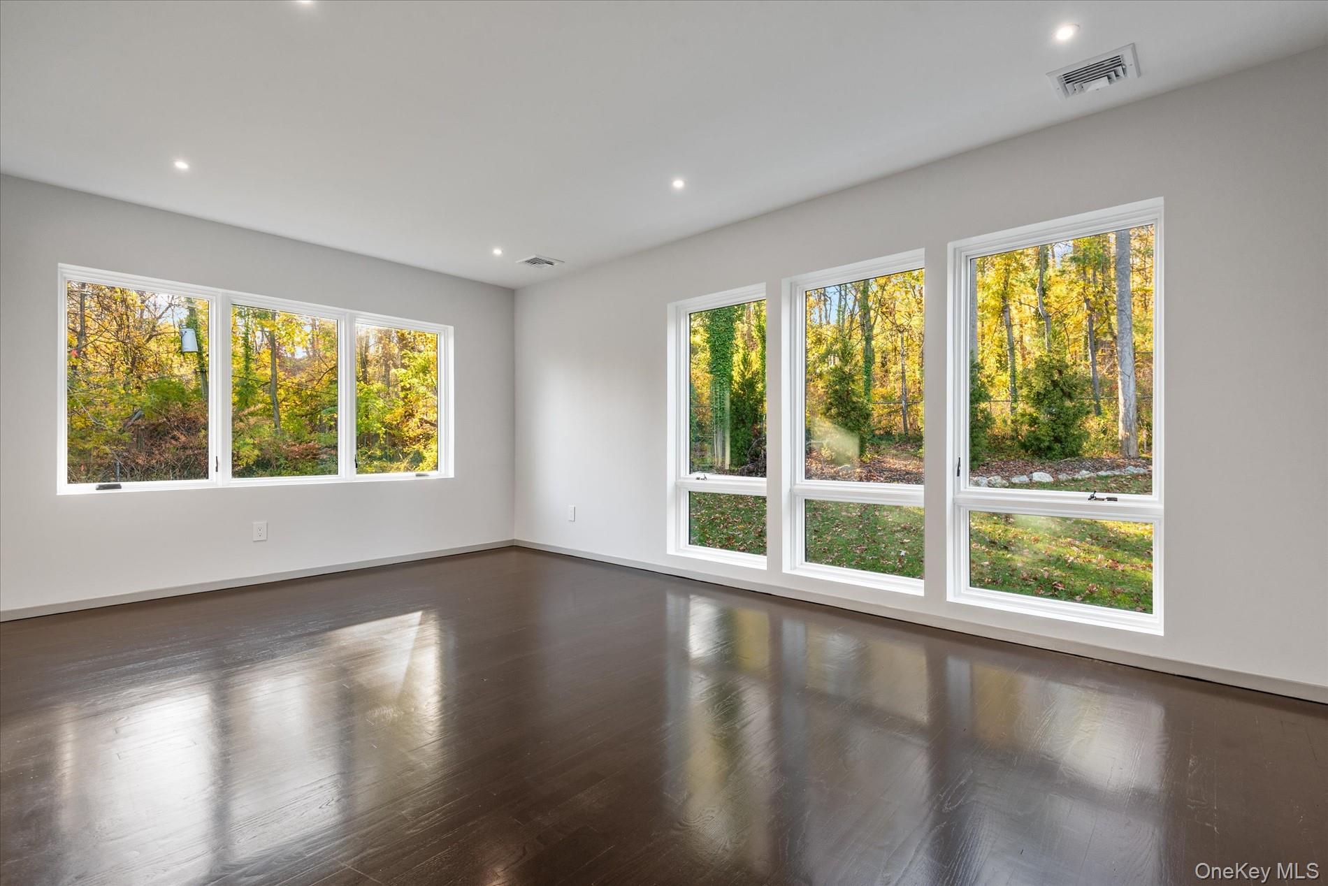 369 East Shore Road Great Neck, NY 11023 - Photo 34 of 50 a view of an empty room with wooden floor and a window