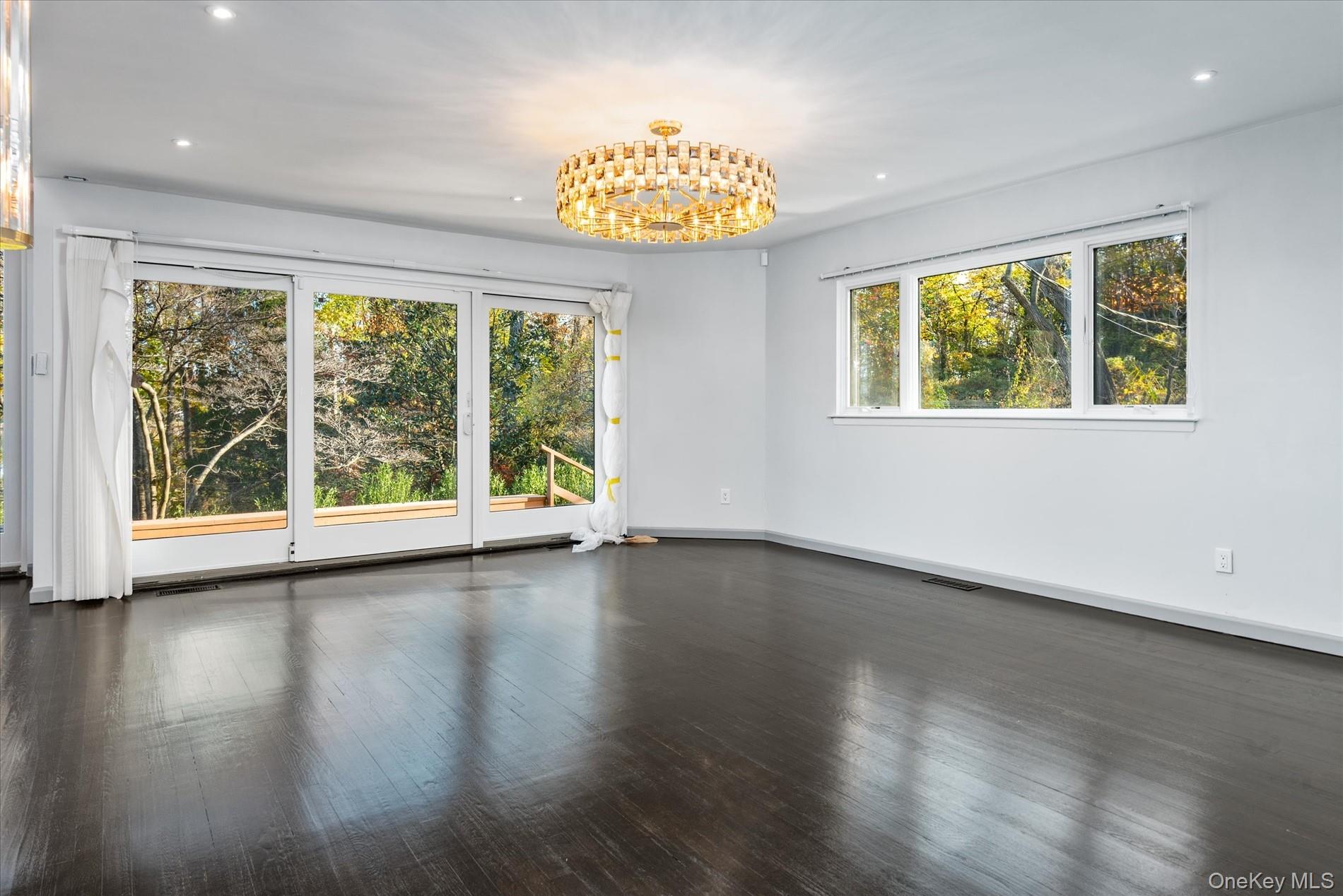 369 East Shore Road Great Neck, NY 11023 - Photo 36 of 50 a view of an empty room with wooden floor and a window