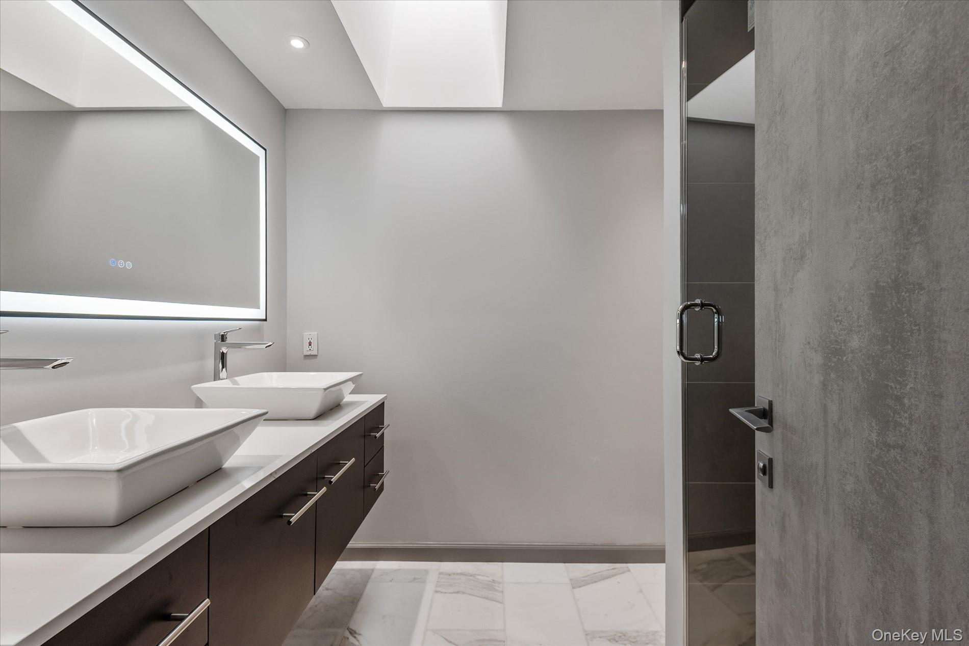 369 East Shore Road Great Neck, NY 11023 - Photo 37 of 50 a bathroom with a sink and a mirror