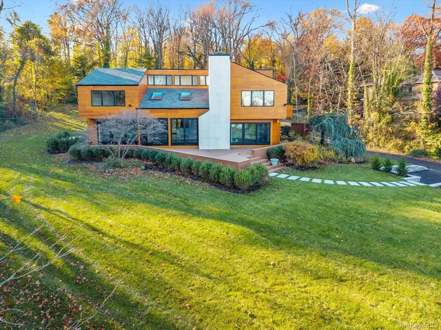 a view of a house with a yard and tree s