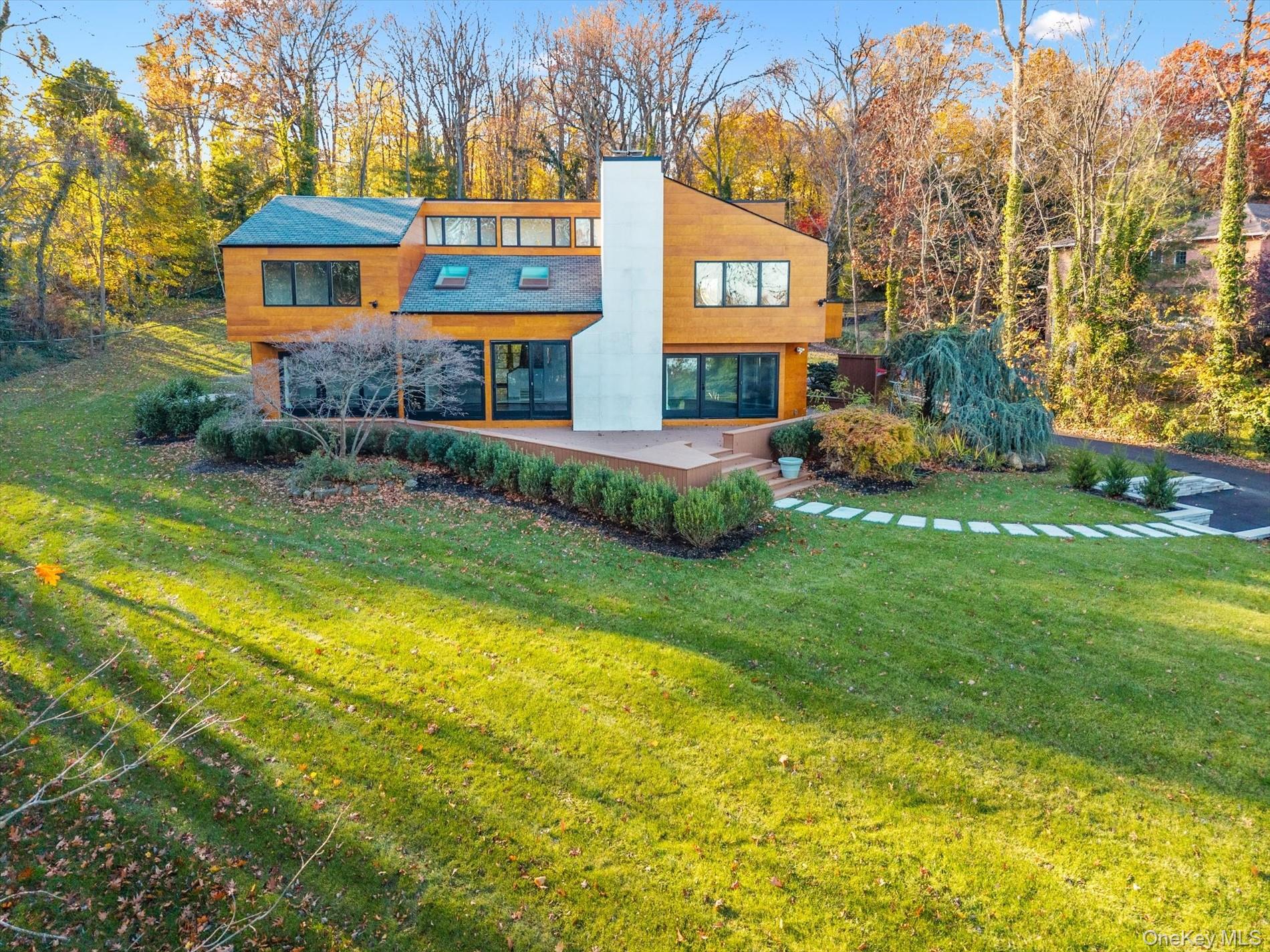 369 East Shore Road Great Neck, NY 11023 - Photo 43 of 50 a view of a house with a yard and tree s