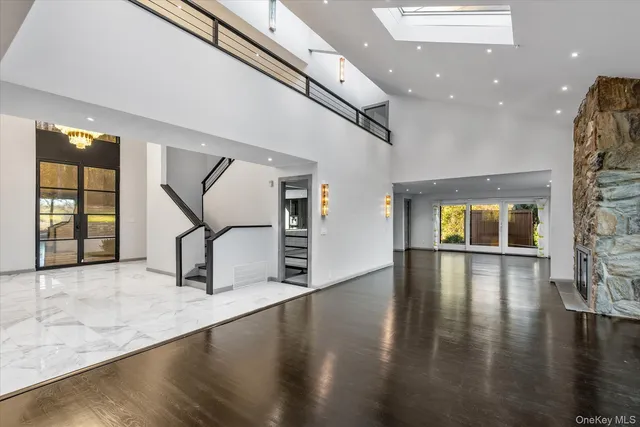 an entryway in a hall with a window and wooden floor