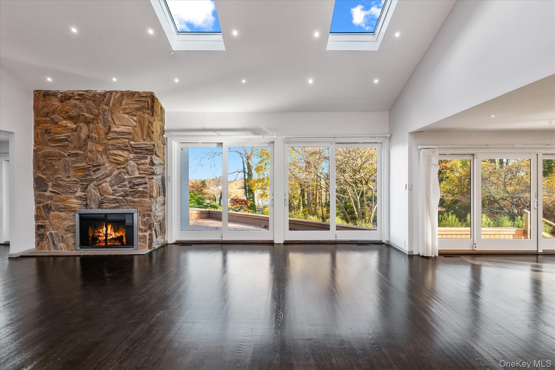 369 East Shore Road Great Neck, NY 11023 - Photo 9 of 50 an empty room with wooden floor and a fireplace