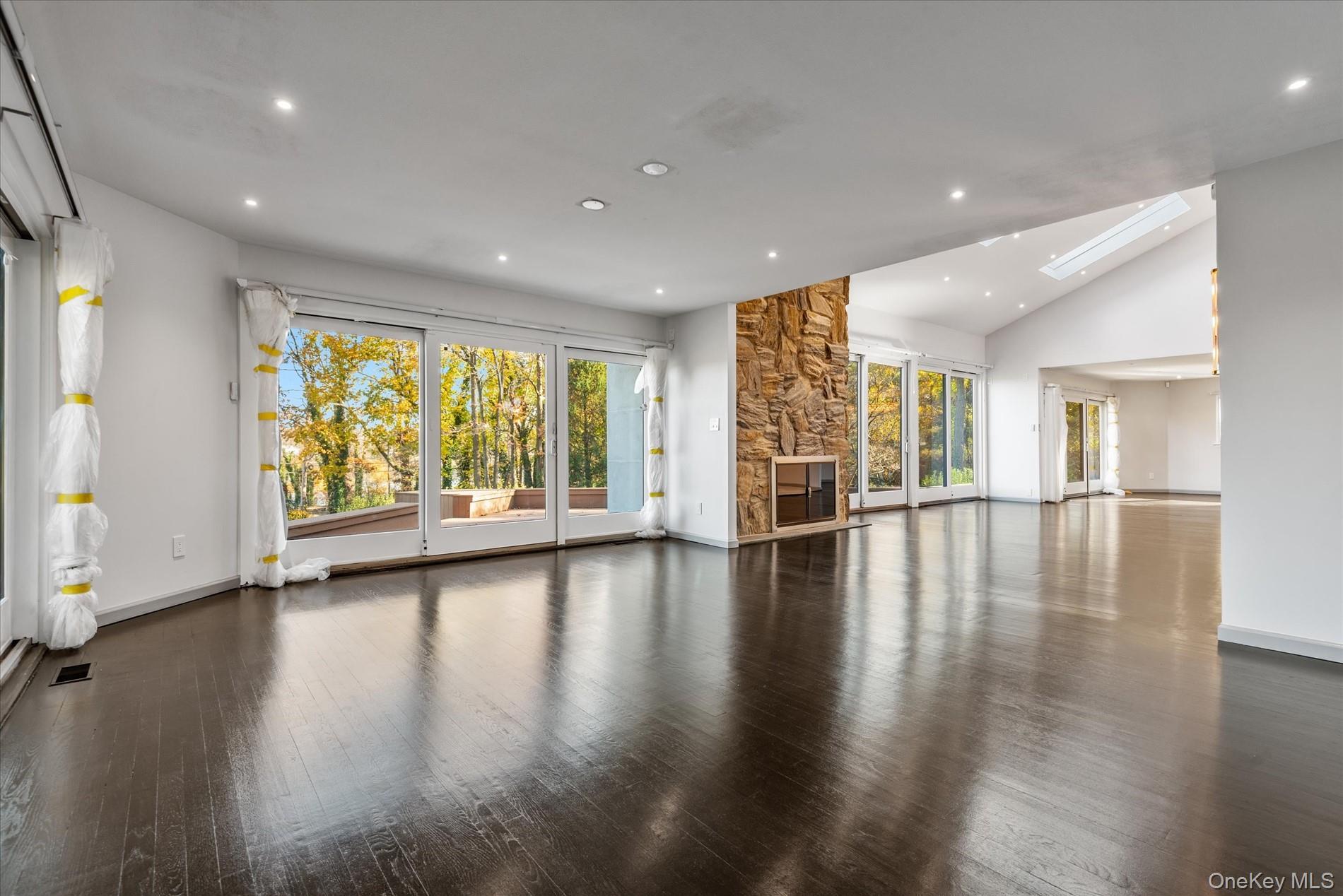 369 East Shore Road Great Neck, NY 11023 - Photo 10 of 50 a view of empty room with wooden floor and floor to ceiling window