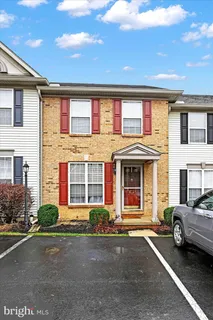 a couple of cars parked in front of a house