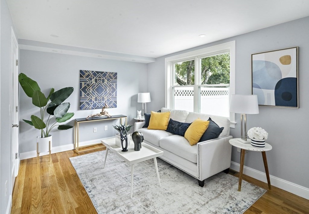 4 Spring St Place Cambridge, MA 02141 - Photo 3 of 12 a living room with furniture and a large window
