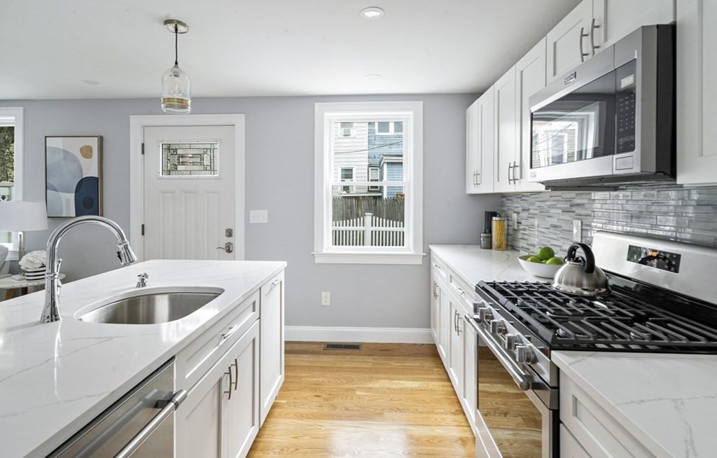 4 Spring St Place Cambridge, MA 02141 - Photo 5 of 12 a kitchen that has a sink and a stove