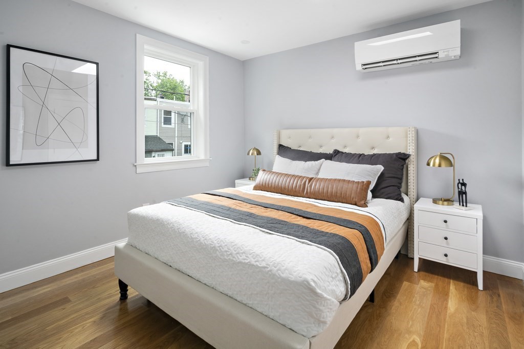 4 Spring St Place Cambridge, MA 02141 - Photo 6 of 12 a bedroom with a bed and window