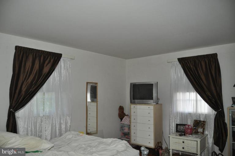 10507 Gateridge Road Cockeysville, MD 21030 - Photo 16 of 18 a bedroom with a bed and a flat screen tv