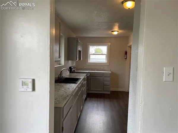 a bathroom with a granite countertop sink a vanity and a mirror