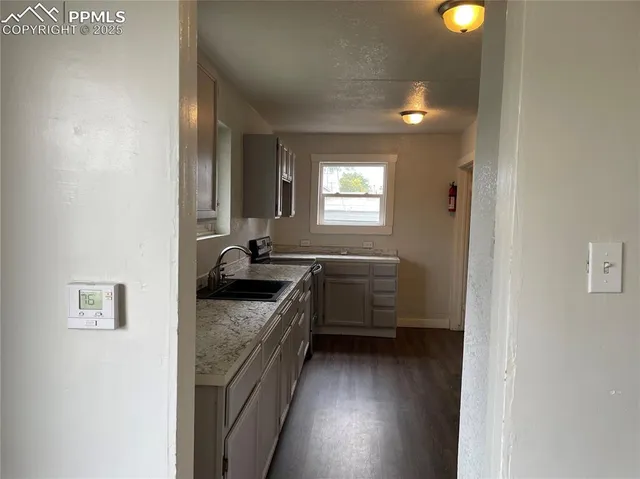 a bathroom with a granite countertop sink a vanity and a mirror