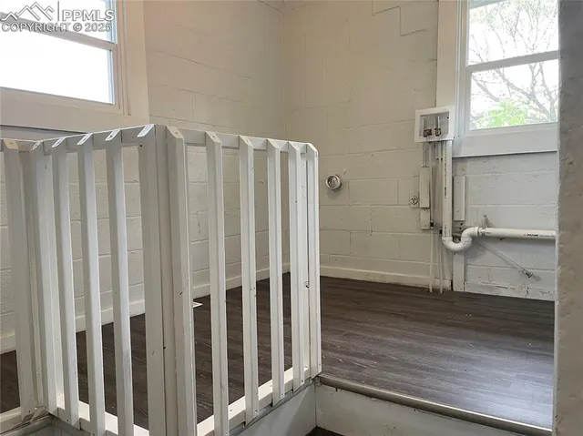 a view of a closet area with wooden floor