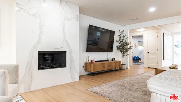 a kitchen with stainless steel appliances kitchen island granite countertop a refrigerator and a dining table