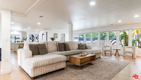 a kitchen with stainless steel appliances granite countertop a sink a stove and a refrigerator