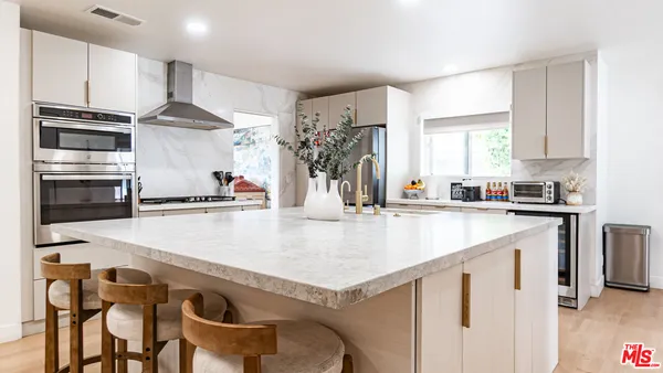 a kitchen with granite countertop a stove and a refrigerator