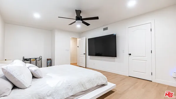 a bedroom with furniture and a book shelf