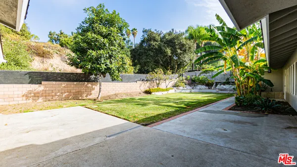 an aerial view of a house with yard swimming pool and outdoor seating