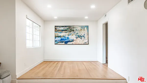 a bedroom with a bed and a television