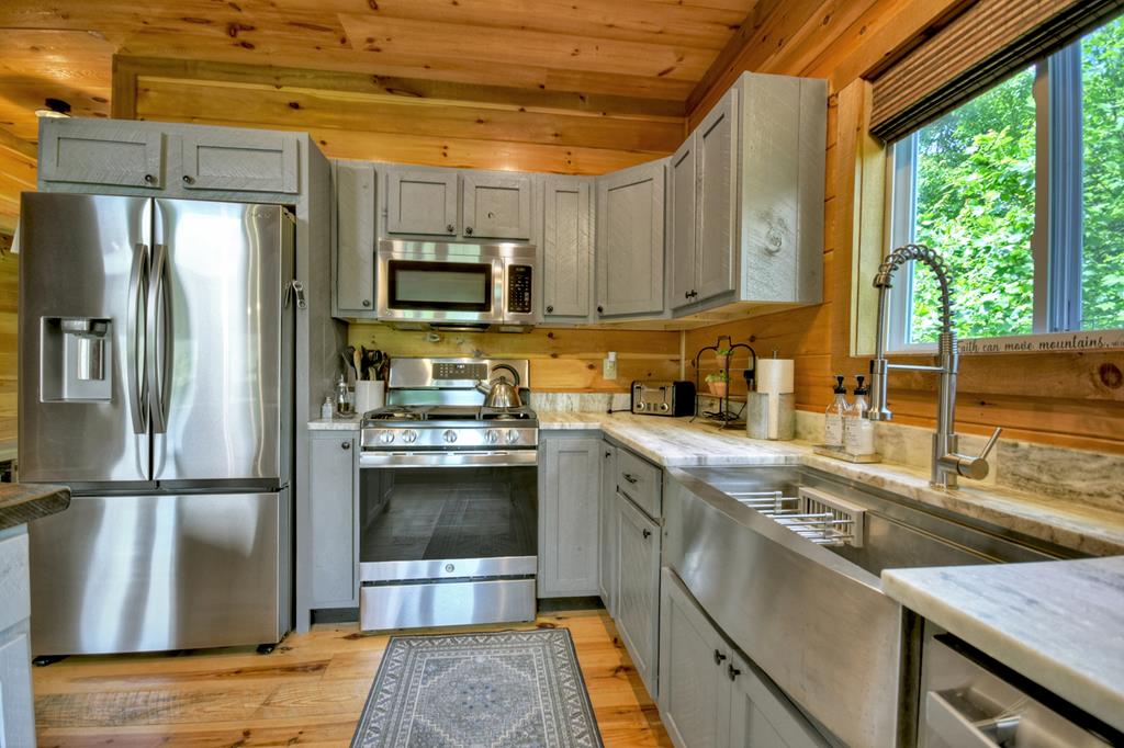 80 Tom Tom Trail Blue Ridge, GA 30513 - Photo 49 of 67 a kitchen with stainless steel appliances granite countertop a refrigerator a sink and a stove