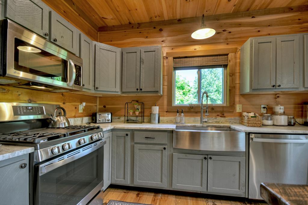 80 Tom Tom Trail Blue Ridge, GA 30513 - Photo 50 of 67 a kitchen with stainless steel appliances granite countertop a sink a stove a microwave and cabinets