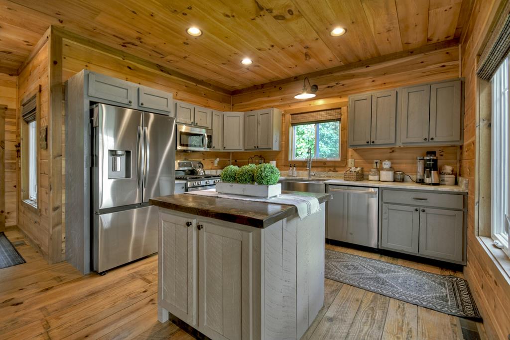 80 Tom Tom Trail Blue Ridge, GA 30513 - Photo 57 of 67 a kitchen with granite countertop a refrigerator a sink a stove and cabinets