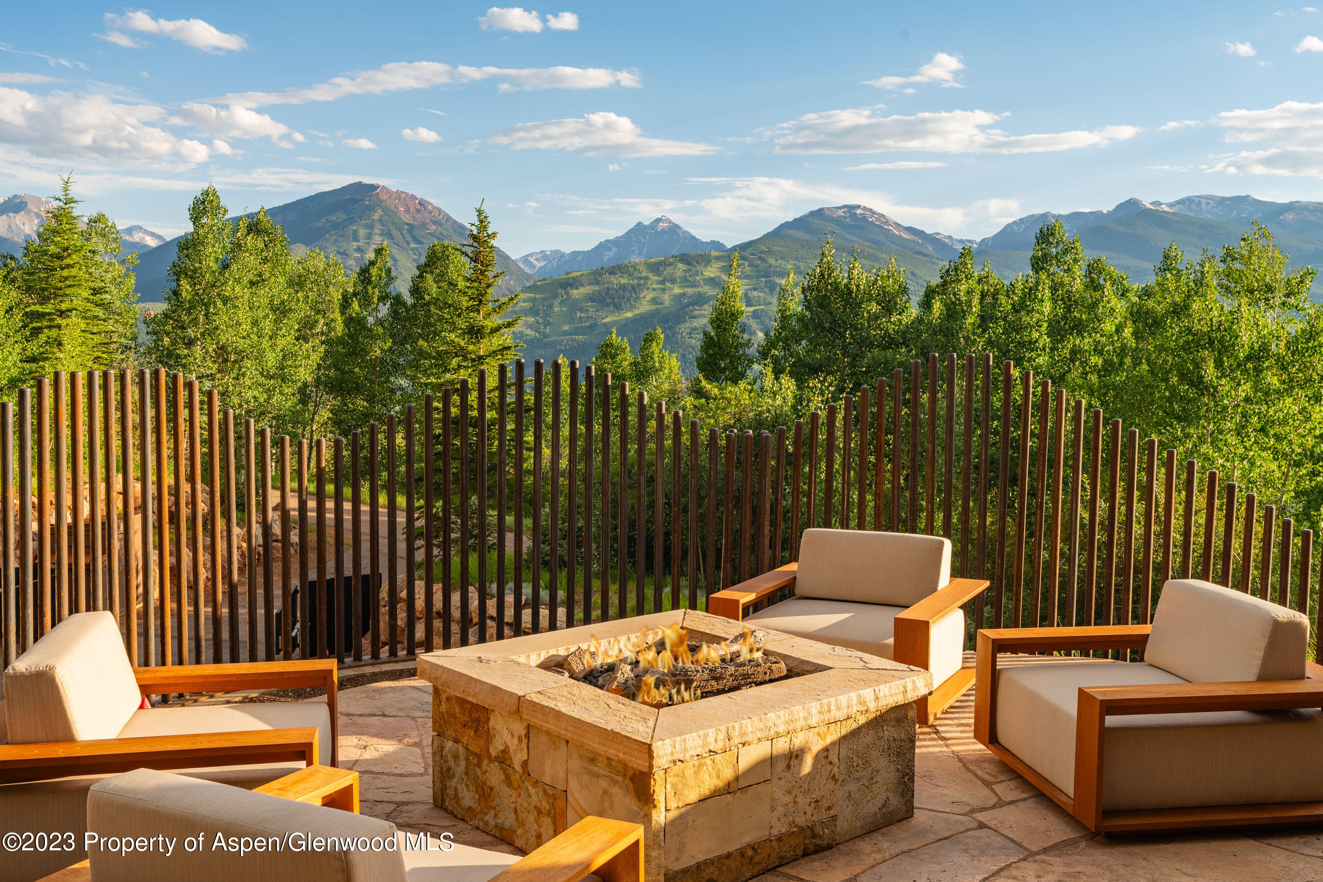 70 Larson Road Aspen, CO 81612 - Photo 12 of 55 a view of a patio with a table and chairs with wooden fence