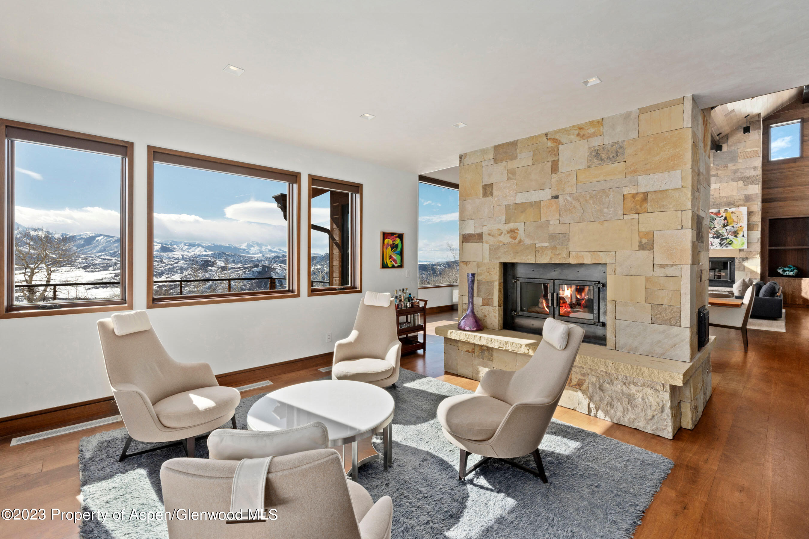 70 Larson Road Aspen, CO 81612 - Photo 18 of 55 a living room with furniture a fireplace and a large window
