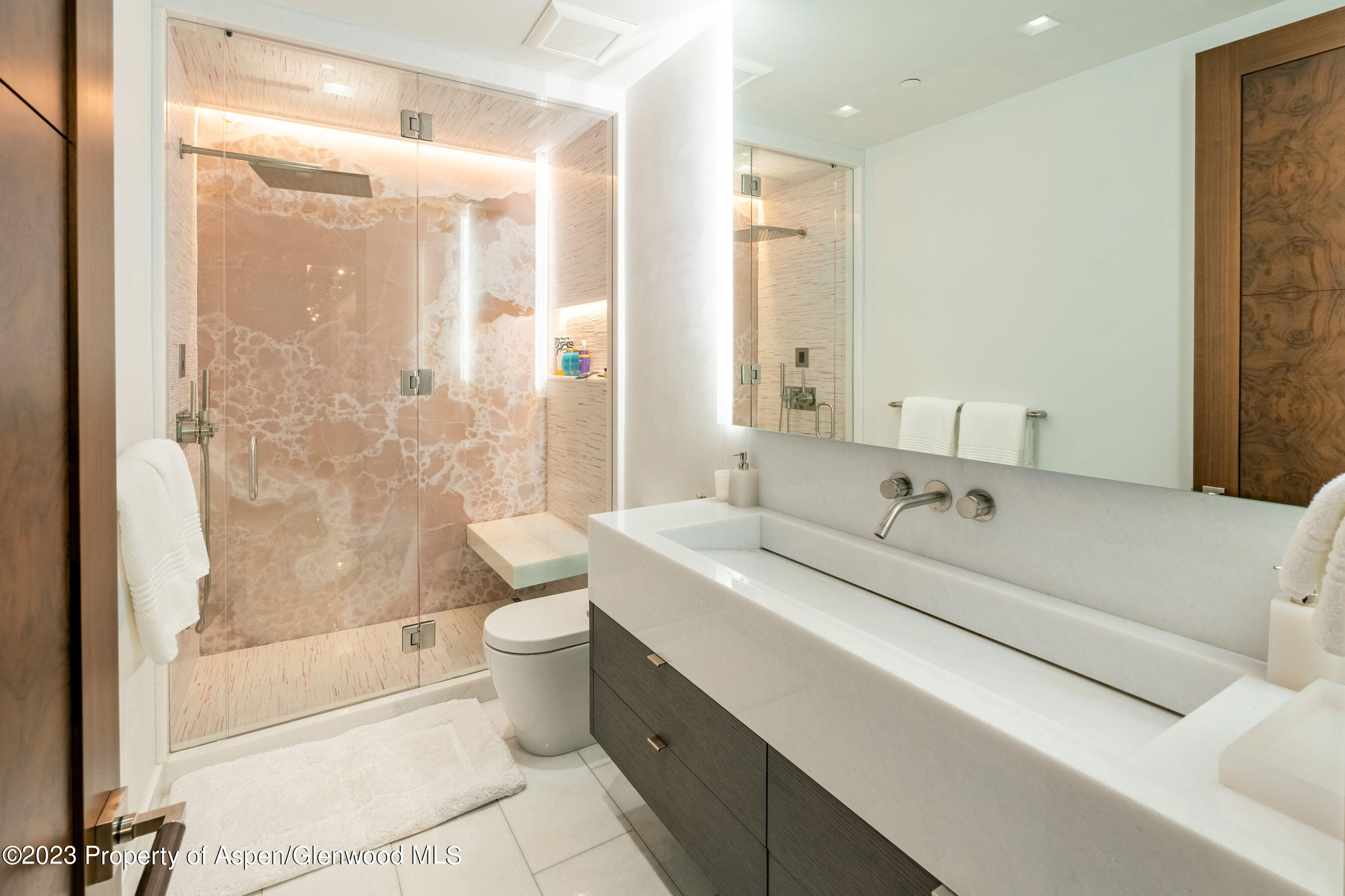 70 Larson Road Aspen, CO 81612 - Photo 21 of 55 a bathroom with a double vanity sink toilet mirror and shower