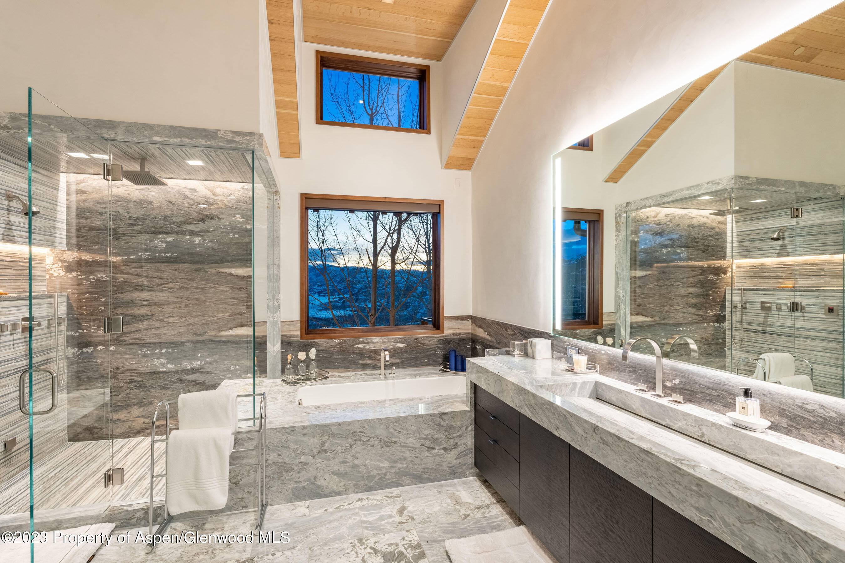 70 Larson Road Aspen, CO 81612 - Photo 23 of 55 a bathroom with a granite countertop sink and a mirror