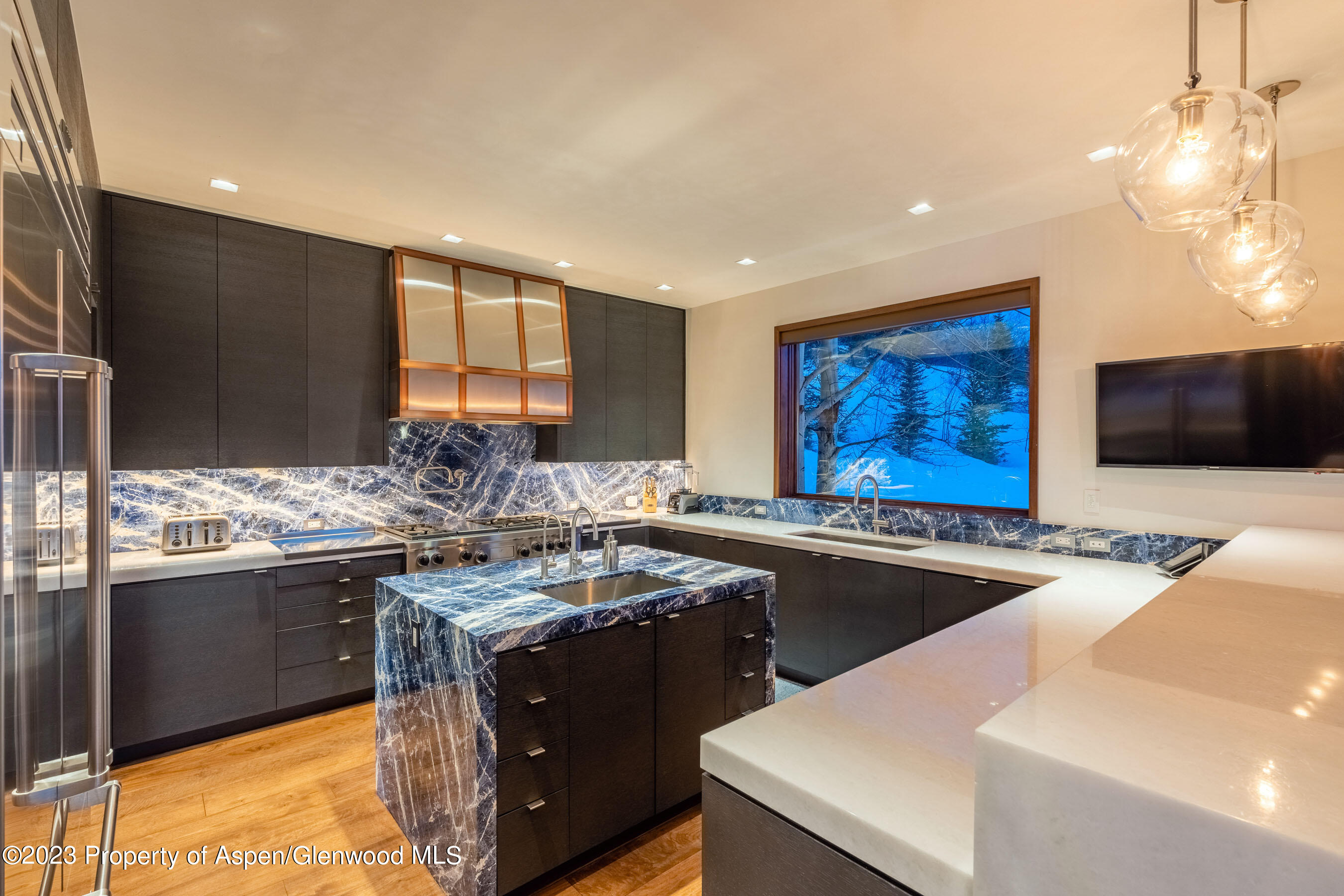 70 Larson Road Aspen, CO 81612 - Photo 25 of 55 a kitchen with stainless steel appliances granite countertop a sink stove and refrigerator