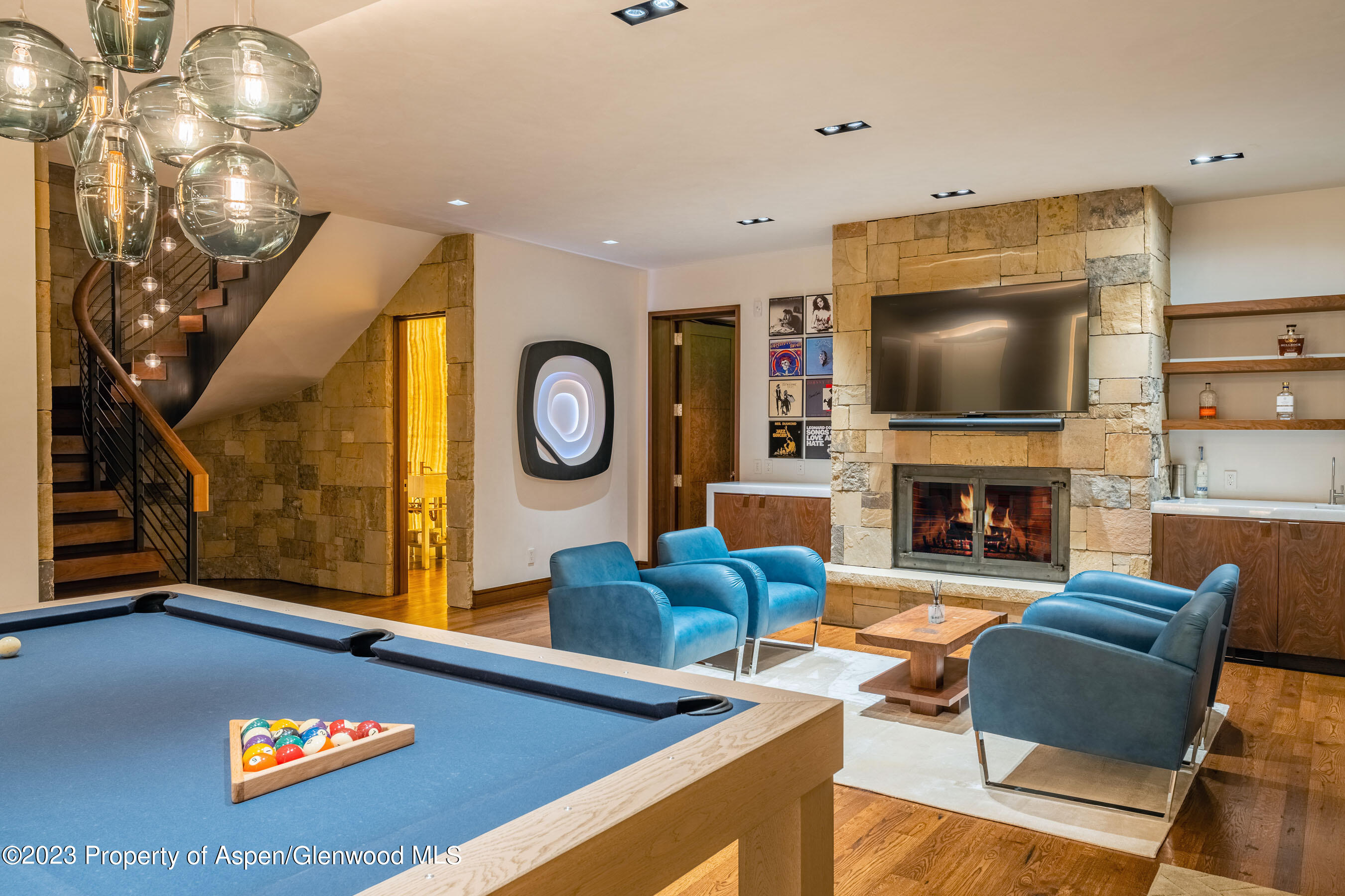 70 Larson Road Aspen, CO 81612 - Photo 34 of 55 a living room with furniture a flat screen tv and a fireplace