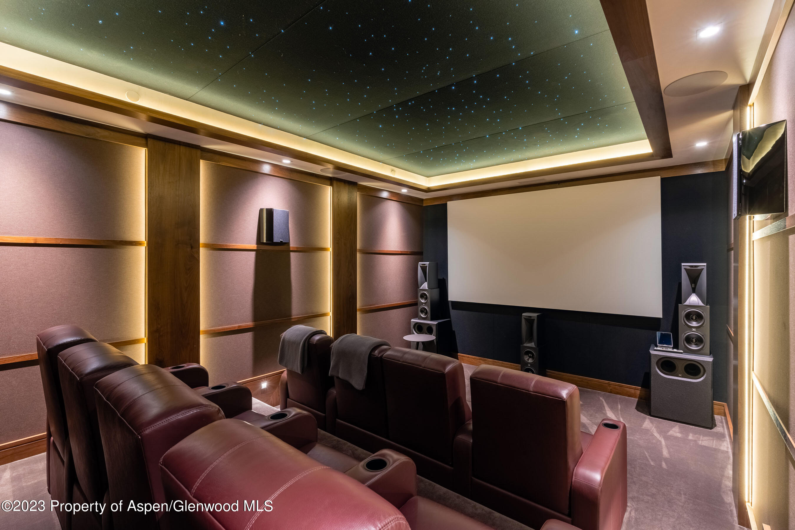 70 Larson Road Aspen, CO 81612 - Photo 39 of 55 a media room with lots of chairs and a projector screen
