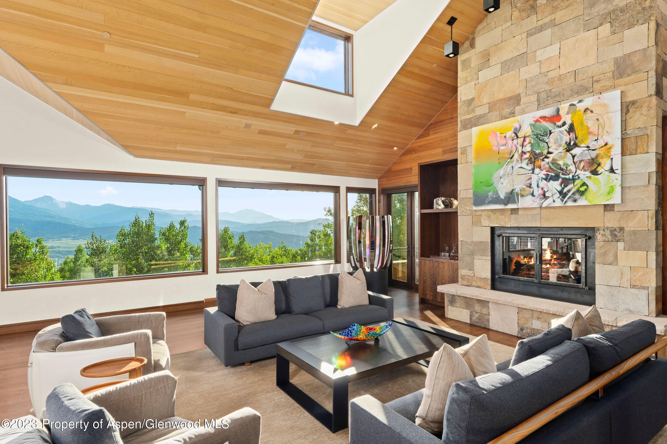 70 Larson Road Aspen, CO 81612 - Photo 45 of 55 a living room with fireplace furniture and a floor to ceiling window