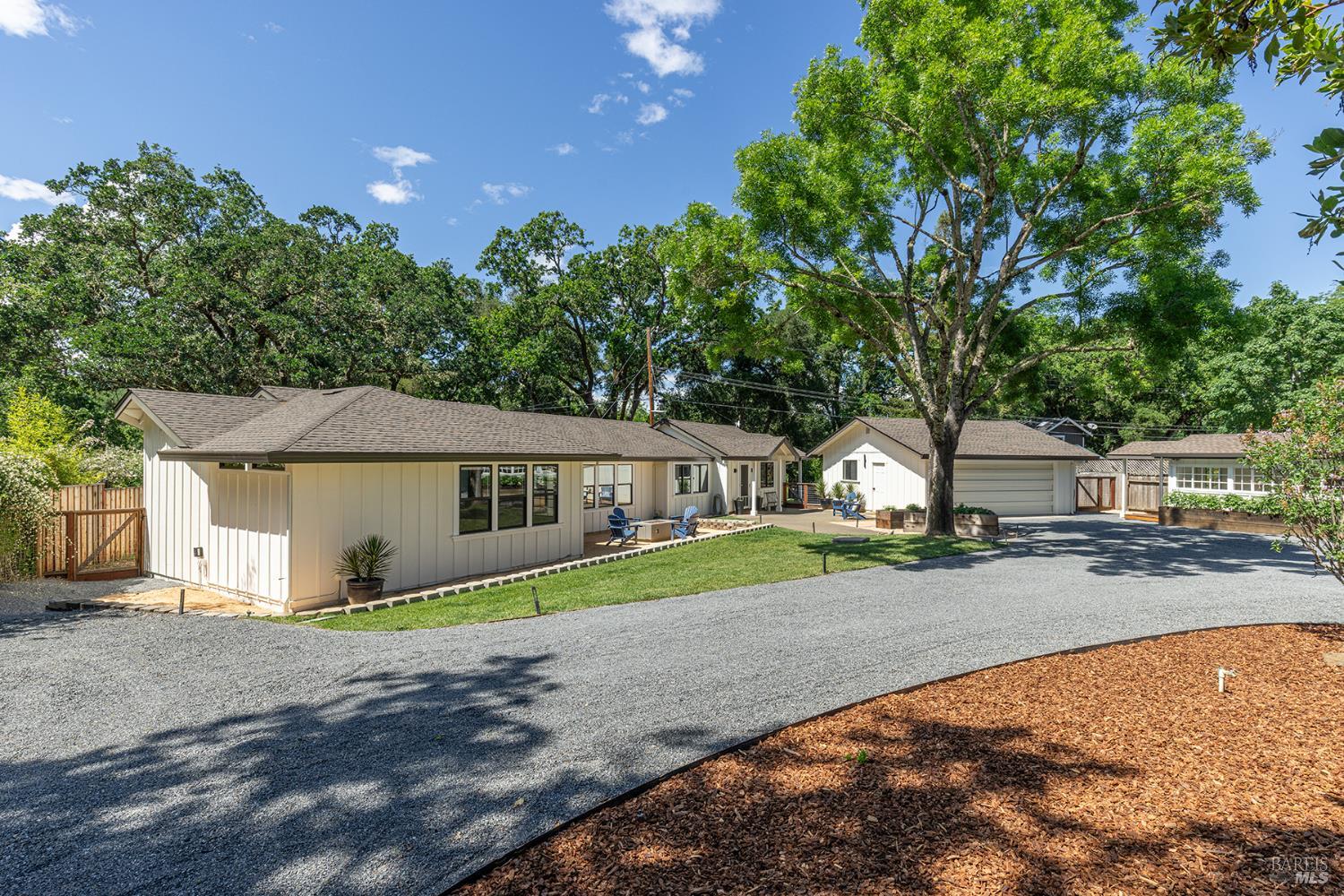 14734 Young Road Healdsburg, CA 95448 - Photo 3 of 47 a front view of a house with a garden and trees