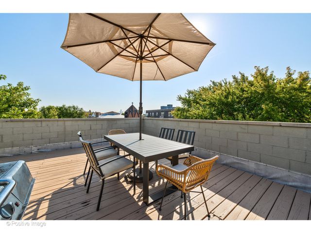 a view of a brick house with a large windows and a tree