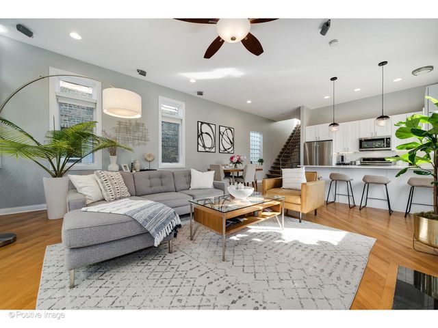 a kitchen with granite countertop a refrigerator and a dining table