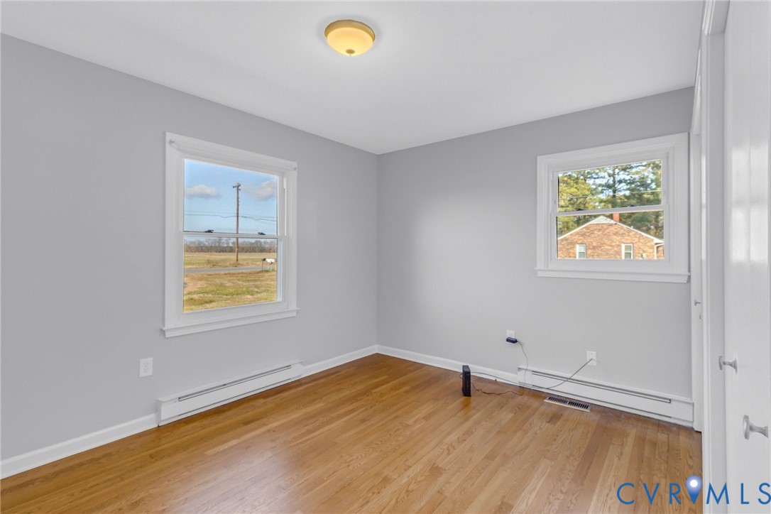 1928 Lake Road Lottsburg, VA 22511 - Photo 19 of 47 an empty room with a wooden floor and a window
