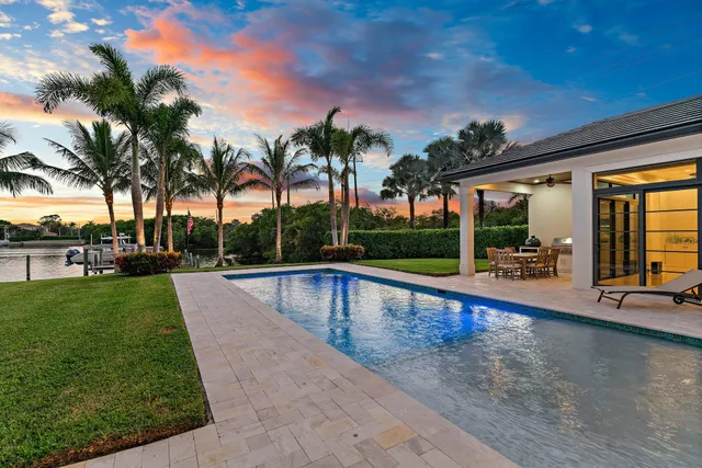 a view of swimming pool with a patio and a yard