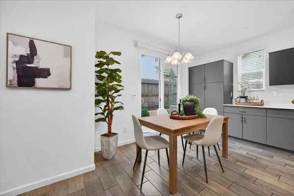 a view of a dining room with furniture wooden floor and chandelier