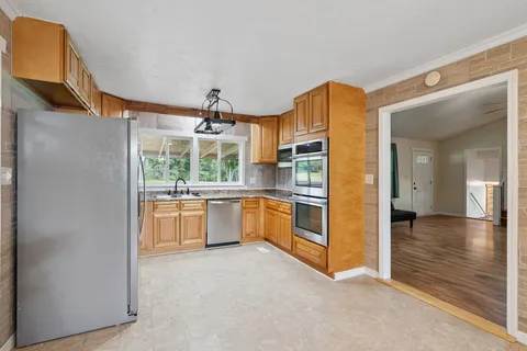 a kitchen with a refrigerator and a sink