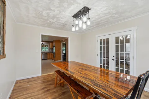 a view of a dining room with furniture wooden floor and chandelier